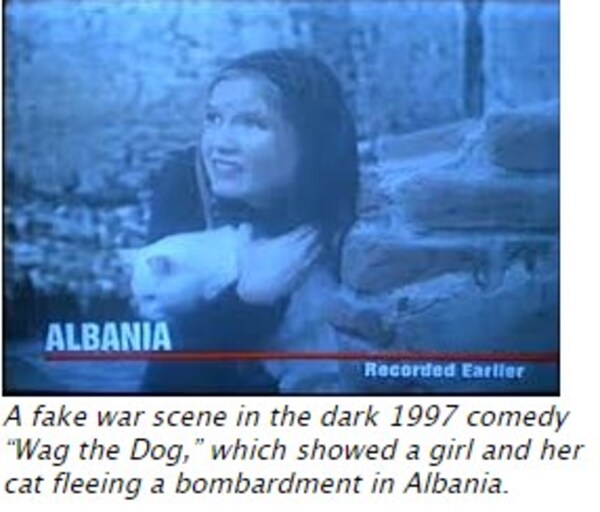 Another screencap from the movie Wag The Dog: The resulting news footage of a young blond woman in front of a damages building.