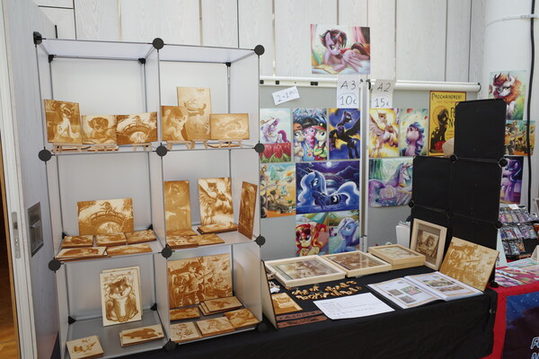 Laser-engraved wood stuff by Dranaar. Paintings by Yulyeen. I hope those wood-pieces sell better than they did when I last spoke to him. The quality of those pictures has increased since then. They look perfect. Maybe I'll get another one next year if I see one that I like especially.